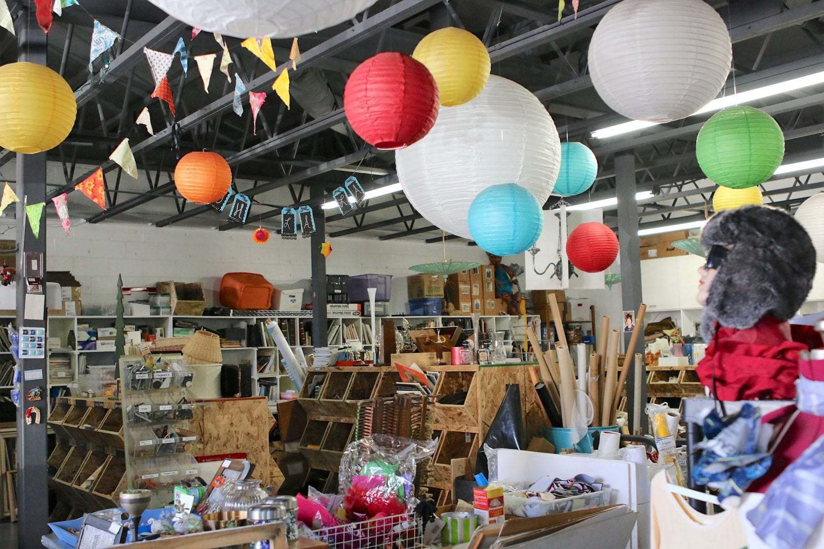 creative reuse store with wooden shelves and various art materials