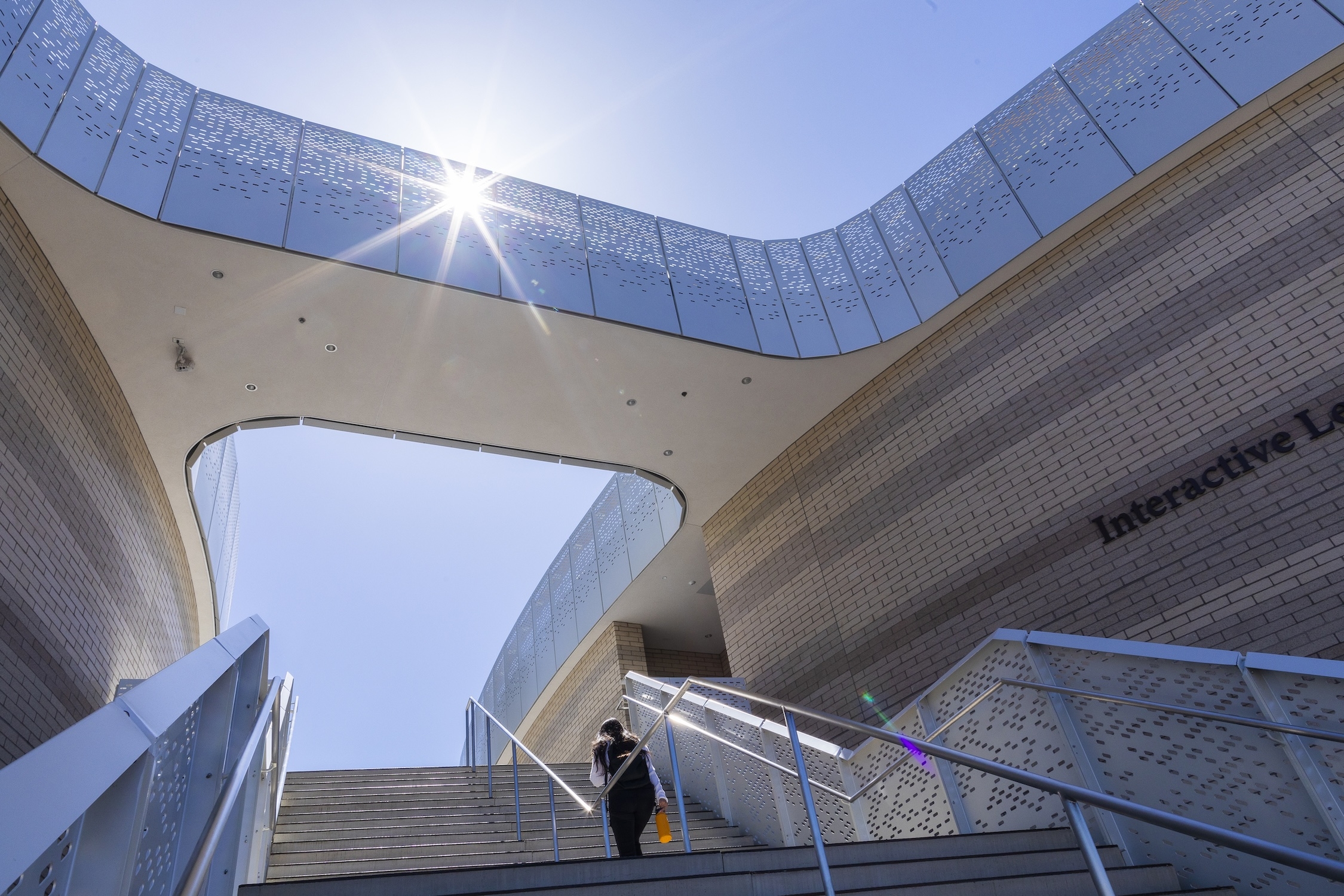 An individual going up the stairs of ILP building 