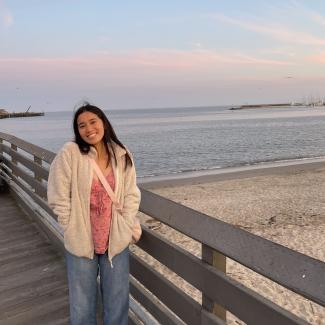 Amber standing next to the ocean 